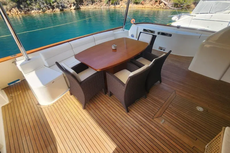  Yacht Photos Pics Luxurious 2011 Custom Line Navetta 26 yacht deck with elegant seating and scenic water view.