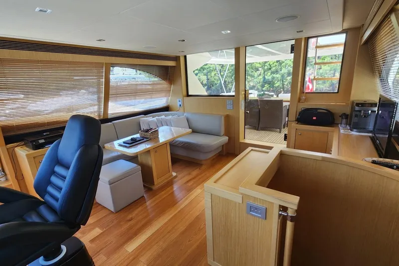  Yacht Photos Pics Luxurious interior of 2011 Custom Line Navetta 26 yacht with modern furnishings and wooden accents.