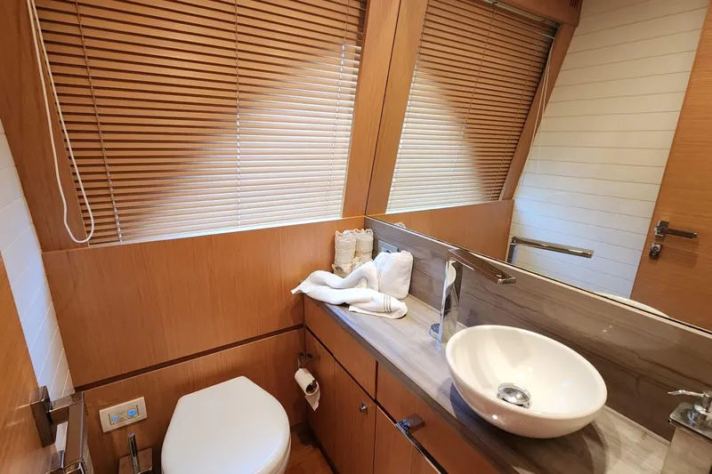  Yacht Photos Pics Luxurious bathroom in 2011 Custom Line Navetta 26 yacht with modern fixtures and wooden accents.