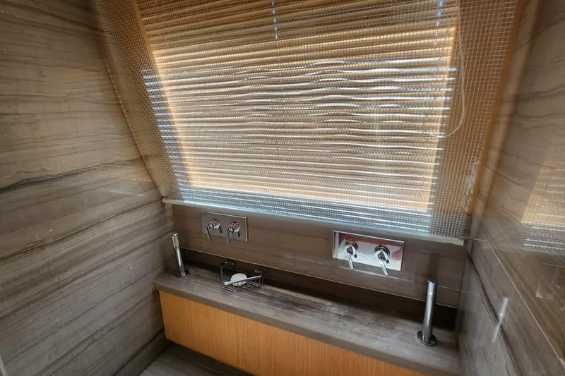  Yacht Photos Pics Luxurious bathroom interior of 2011 Custom Line Navetta 26 yacht with modern fixtures.