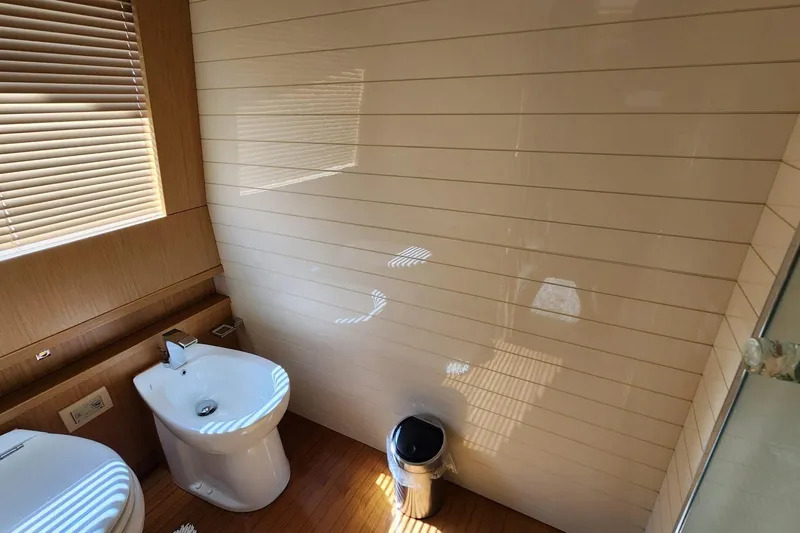  Yacht Photos Pics Luxurious bathroom on 2011 Custom Line Navetta 26 yacht with modern fixtures and wooden accents.