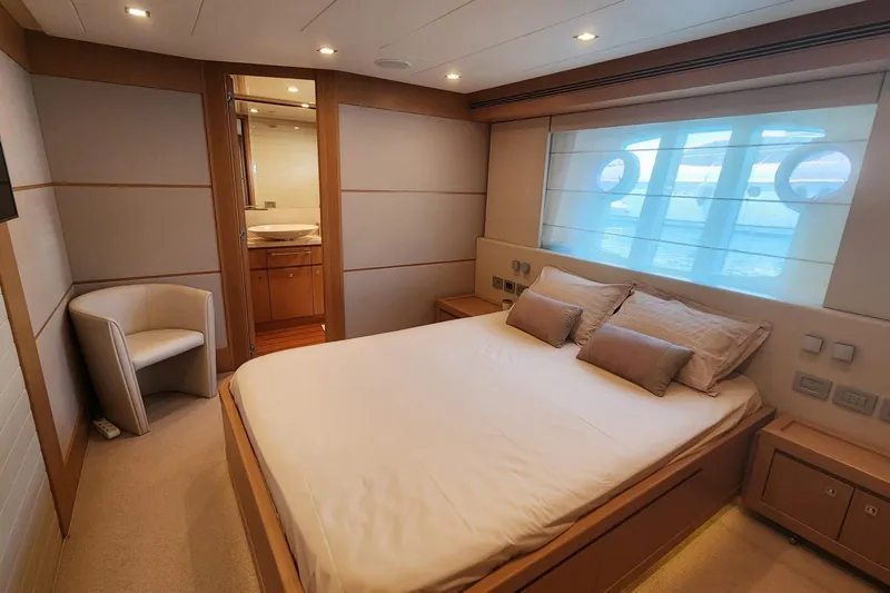  Yacht Photos Pics Luxurious bedroom on 2011 Custom Line Navetta 26 yacht with modern decor and ocean view.