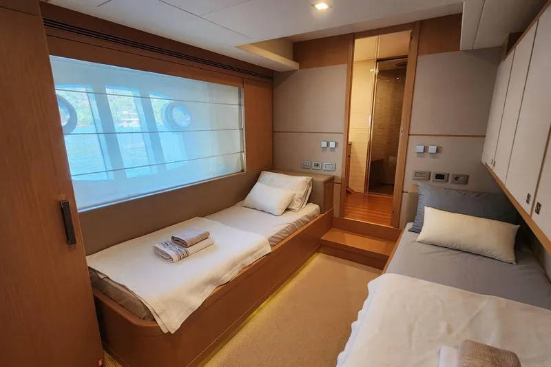  Yacht Photos Pics Luxurious cabin interior of 2011 Custom Line Navetta 26 yacht with twin beds and modern decor.