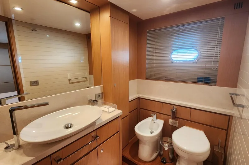  Yacht Photos Pics Luxurious bathroom in 2011 Custom Line Navetta 26 yacht with modern fixtures and wood accents.