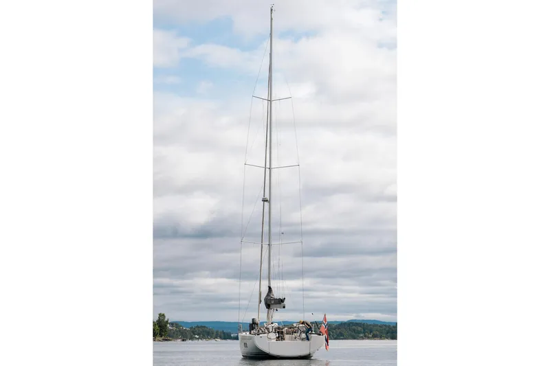 Yacht Photos Pics 2019 Hanse 548 sailboat on calm water under cloudy sky.