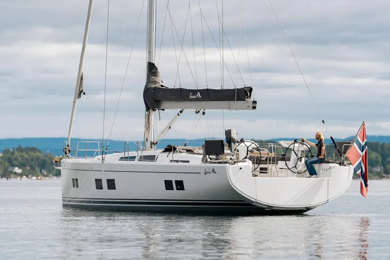  Yacht Photos Pics 2019 Hanse 548 yacht sailing with Norwegian flag on calm waters.