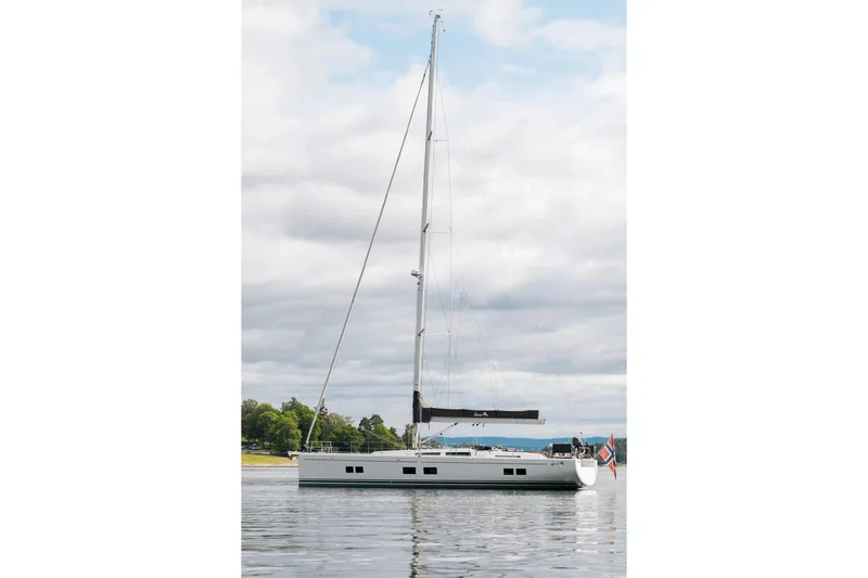  Yacht Photos Pics 2019 Hanse 548 sailboat on calm water under cloudy sky.