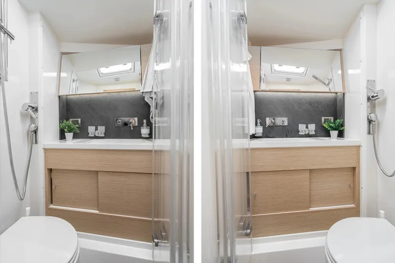  Yacht Photos Pics Modern bathroom interior on 2019 Hanse 548 yacht, featuring sleek design and wooden cabinetry.