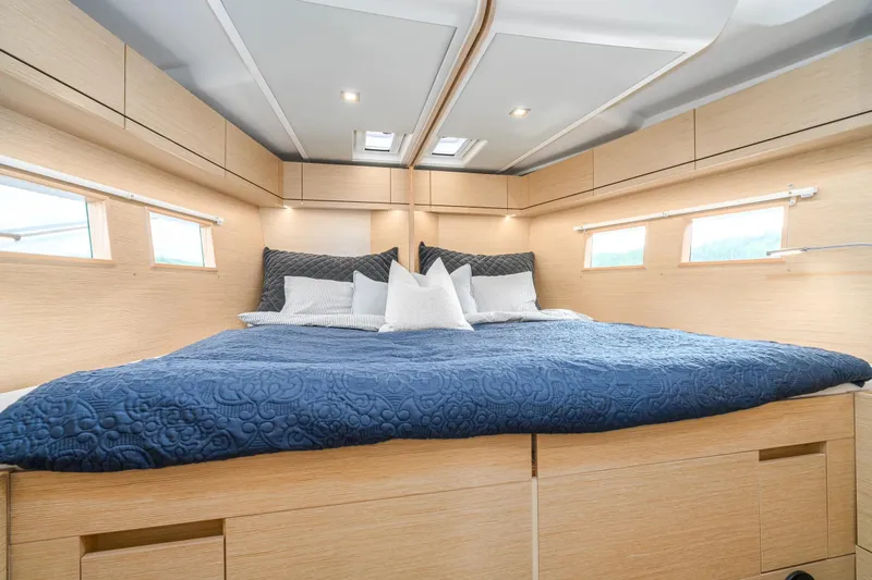  Yacht Photos Pics Luxurious cabin interior of 2019 Hanse 548 yacht with cozy bedding and natural light.