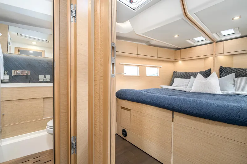  Yacht Photos Pics Luxurious interior of 2019 Hanse 548 yacht with cozy bedroom and modern bathroom.