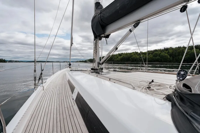  Yacht Photos Pics 2019 Hanse 548 yacht deck with scenic water and forest view.