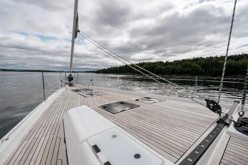  Yacht Photos Pics 2019 Hanse 548 yacht deck with scenic water and forest view.