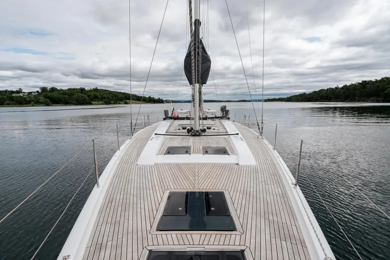  Yacht Photos Pics 2019 Hanse 548 yacht on calm waters, showcasing sleek deck design and scenic surroundings.