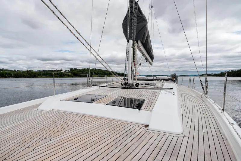  Yacht Photos Pics 2019 Hanse 548 yacht with sleek wooden deck and modern design on calm waters.