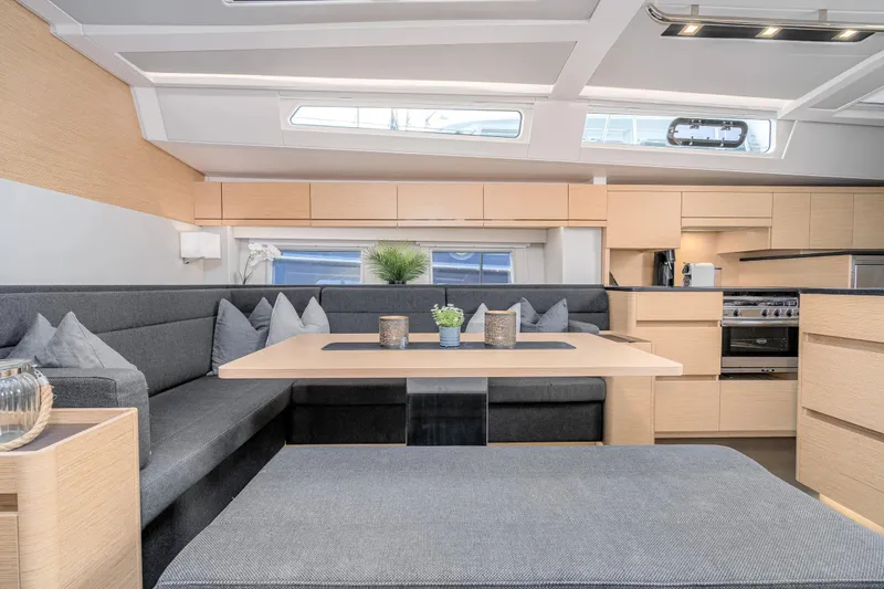  Yacht Photos Pics Modern interior of 2019 Hanse 548 yacht with sleek kitchen and cozy seating area.