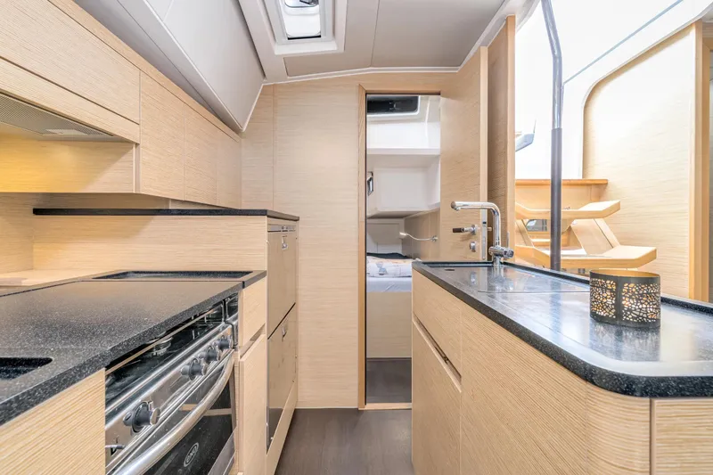  Yacht Photos Pics Modern kitchen interior of 2019 Hanse 548 yacht, featuring sleek countertops and cabinetry.