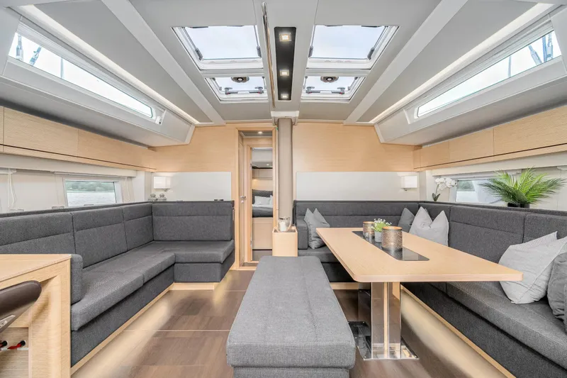  Yacht Photos Pics Luxurious interior of 2019 Hanse 548 yacht with modern seating and skylights.