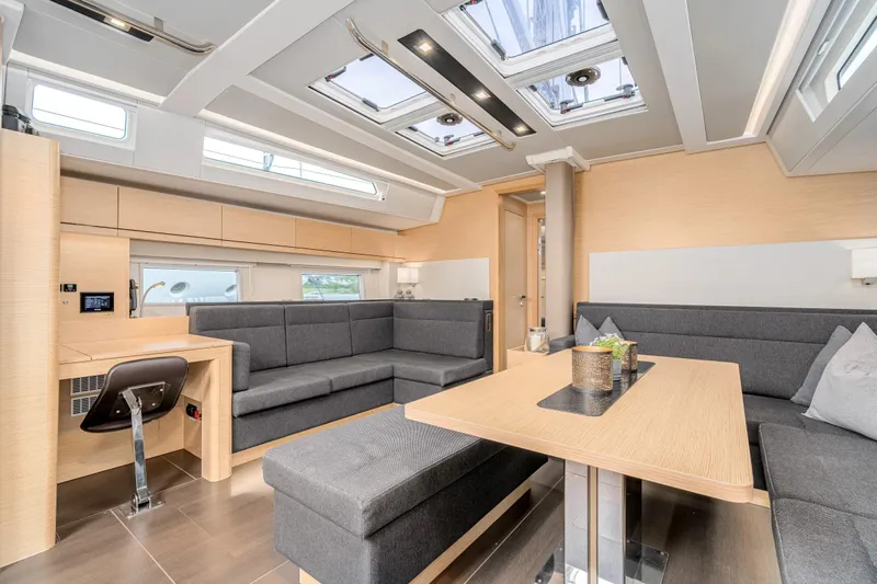  Yacht Photos Pics Luxurious interior of 2019 Hanse 548 yacht with modern seating and skylights.