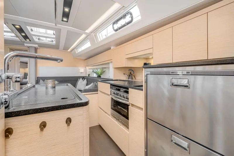  Yacht Photos Pics Modern kitchen interior of 2019 Hanse 548 yacht with sleek cabinetry and stainless steel appliances.