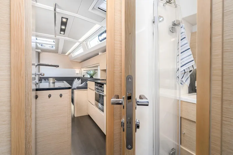  Yacht Photos Pics Modern interior of 2019 Hanse 548 yacht featuring sleek kitchen and bathroom design.