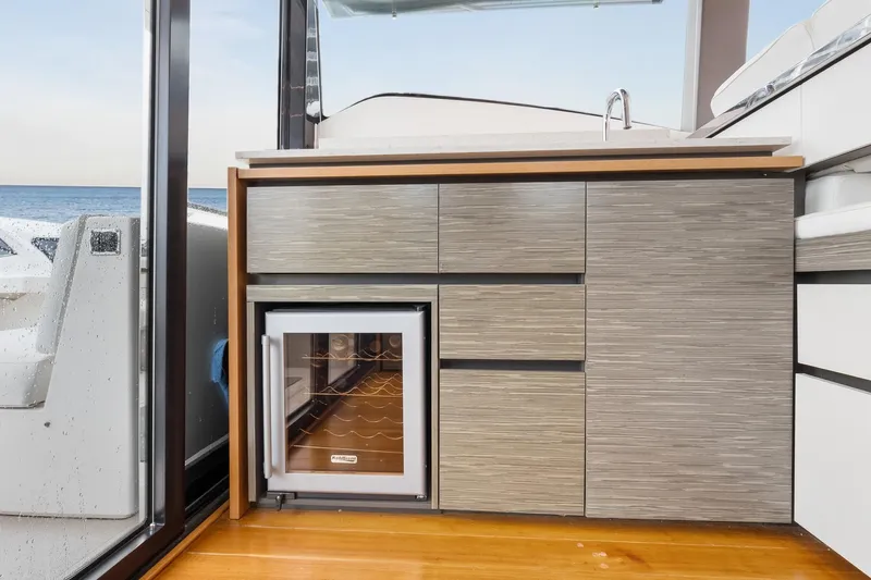 Segers Marine Yacht Photos Pics 2019 Tiara Yachts C49 Coupe interior with modern cabinetry and mini fridge.