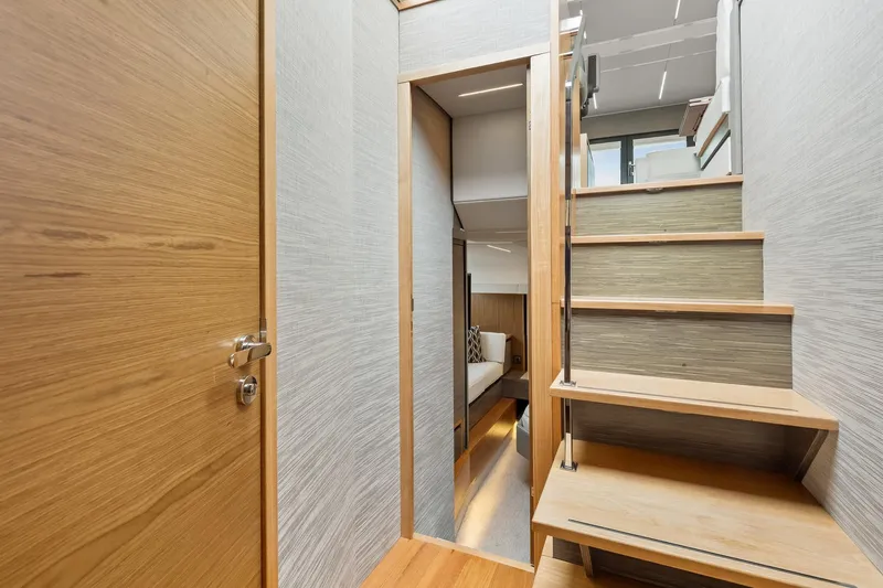 Segers Marine Yacht Photos Pics Interior of 2019 Tiara Yachts C49 Coupe, featuring wooden stairs and modern design.