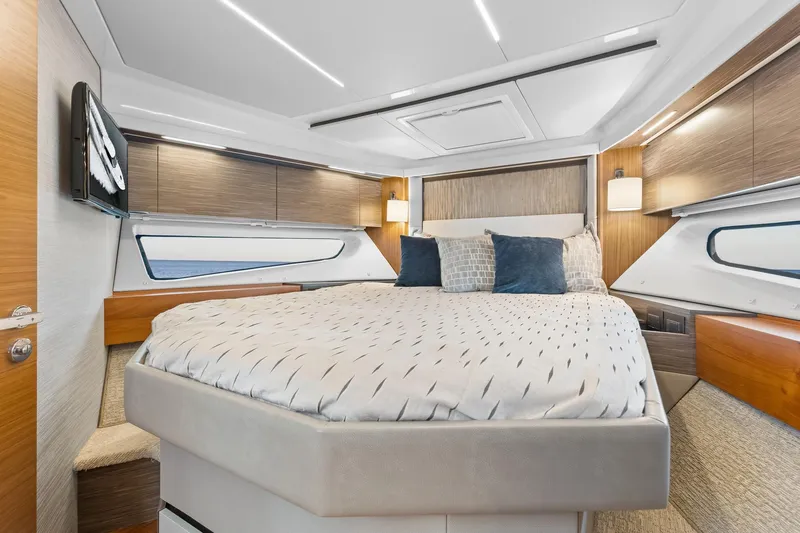 Segers Marine Yacht Photos Pics Luxurious 2019 Tiara Yachts C49 Coupe bedroom with modern design and elegant bedding.
