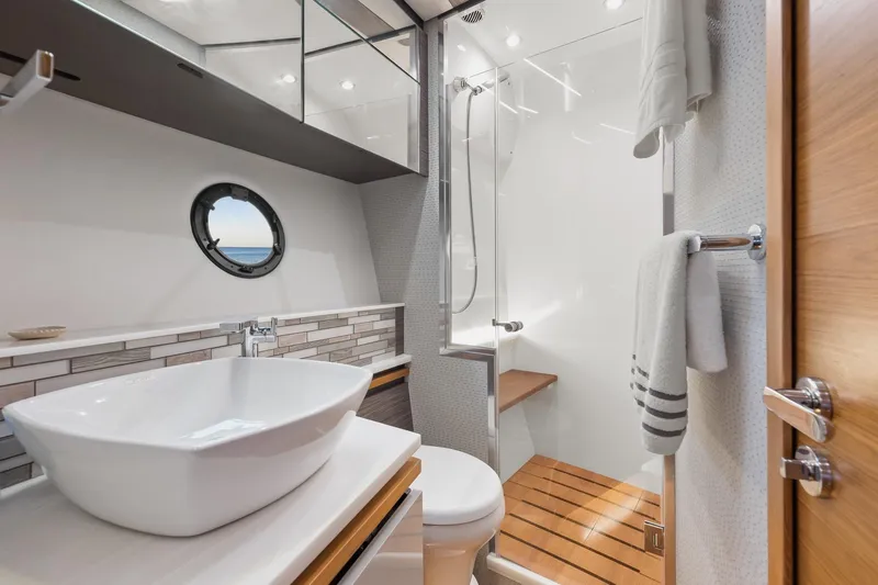 Segers Marine Yacht Photos Pics Luxurious bathroom in 2019 Tiara Yachts C49 Coupe with modern fixtures and elegant design.