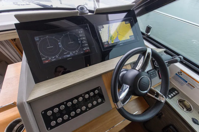 Segers Marine Yacht Photos Pics 2019 Tiara Yachts C49 Coupe helm with advanced navigation displays and steering wheel.