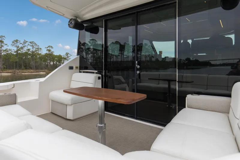 Segers Marine Yacht Photos Pics 2019 Tiara Yachts C49 Coupe interior with white seating and wooden table.