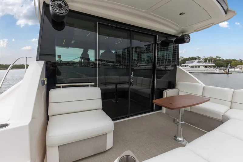 Segers Marine Yacht Photos Pics 2019 Tiara Yachts C49 Coupe with elegant seating and table on deck, docked at marina.