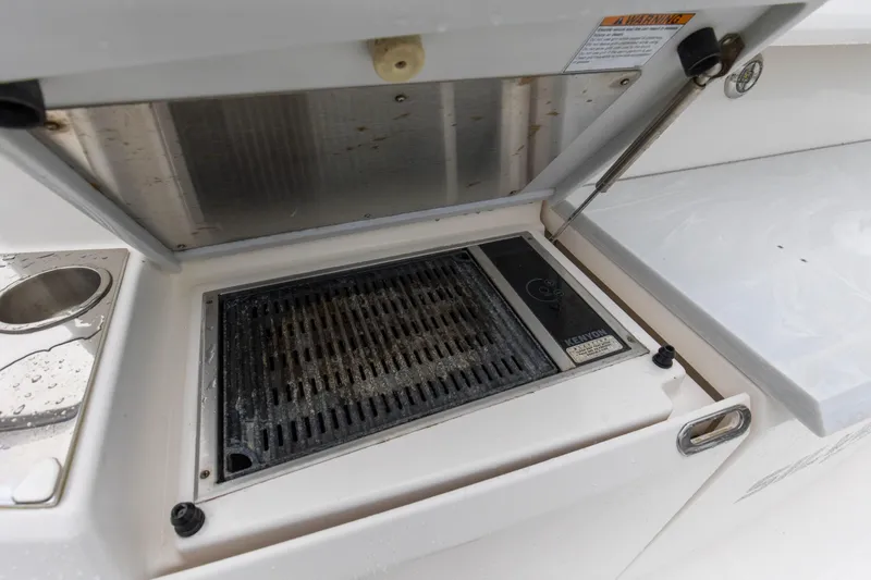 Segers Marine Yacht Photos Pics Outdoor grill on 2019 Tiara Yachts C49 Coupe, featuring Kenyon electric cooktop.