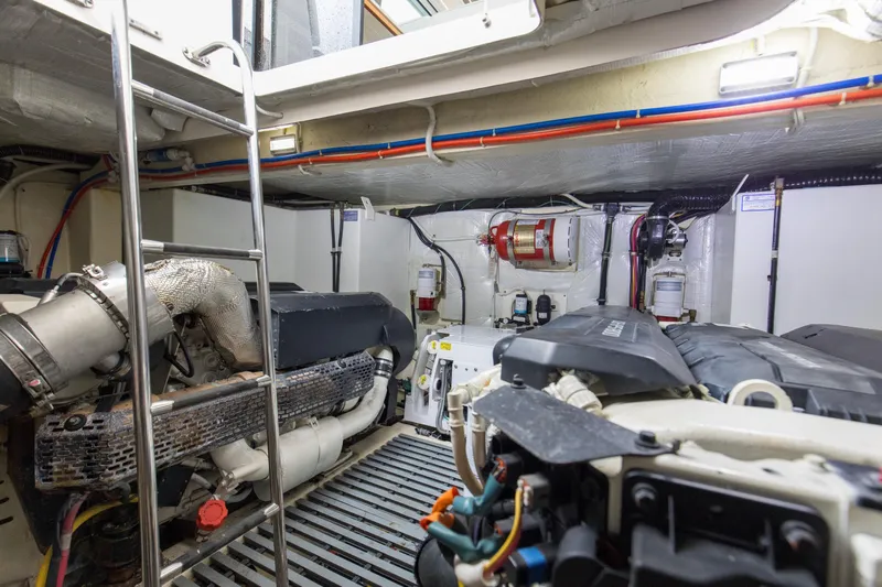 Segers Marine Yacht Photos Pics Engine room of 2019 Tiara Yachts C49 Coupe, featuring mechanical components and ladder.