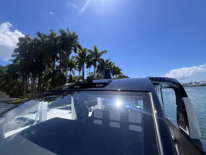  Yacht Photos Pics 2024 Cigarette 42 Auroris boat with palm trees and blue sky background.