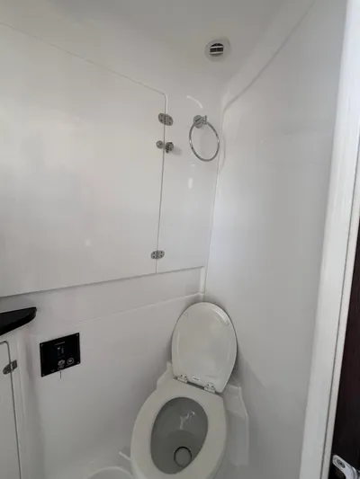  Yacht Photos Pics 2024 Cigarette 42 Auroris boat bathroom with white interior and modern fixtures.