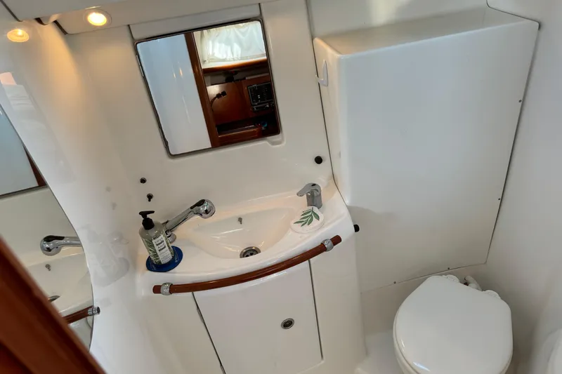 Interlude Yacht Photos Pics Bathroom interior of 2002 Beneteau Oceanis 393 yacht, featuring sink and toilet.