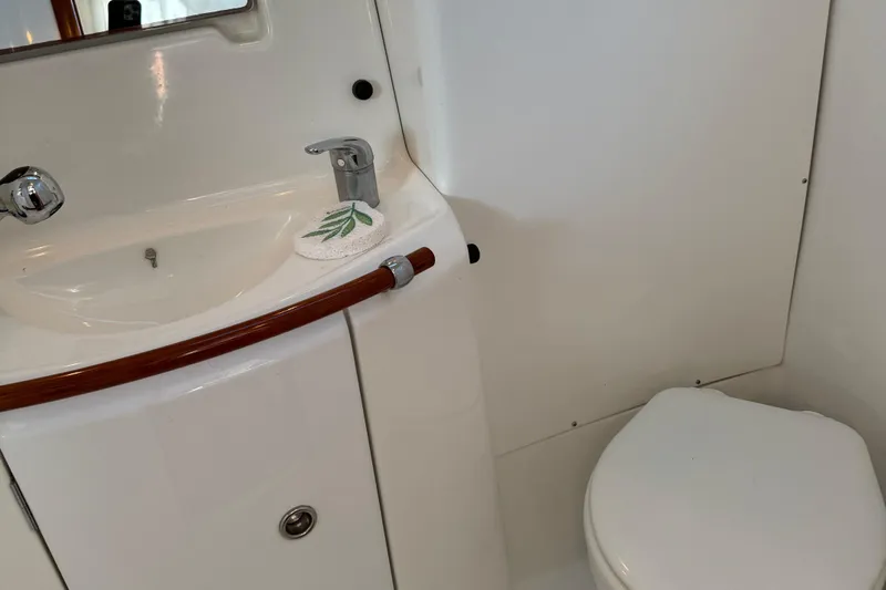 Interlude Yacht Photos Pics Bathroom interior of 2002 Beneteau Oceanis 393 yacht, featuring sink and toilet.