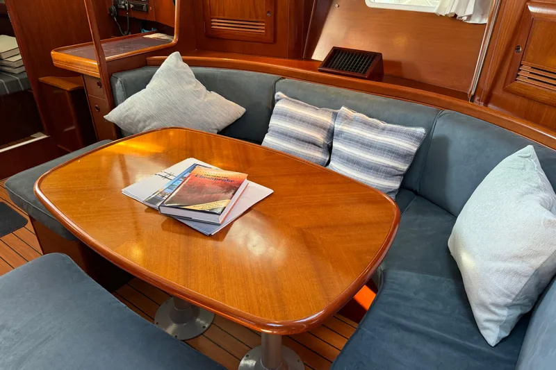 Interlude Yacht Photos Pics Interior of 2002 Beneteau Oceanis 393 yacht with cozy seating and wooden table.
