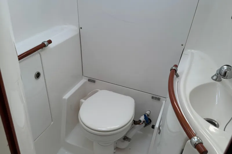 Interlude Yacht Photos Pics Bathroom interior of 2002 Beneteau Oceanis 393 yacht, featuring toilet and sink.