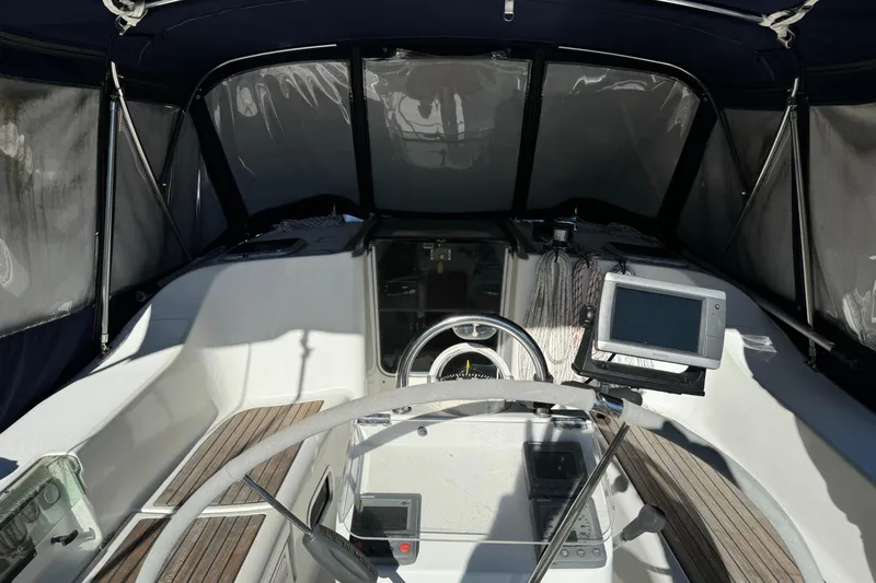 Interlude Yacht Photos Pics Cockpit of 2002 Beneteau Oceanis 393 sailboat with navigation equipment and steering wheel.