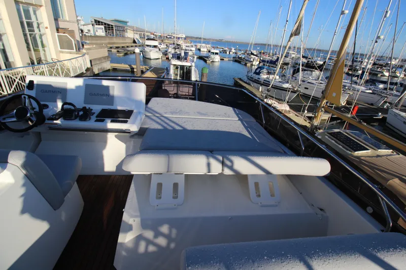 Yacht Photos Pics Flybridge of 2024 Prestige 520 yacht with marina view, featuring Garmin navigation equipment.