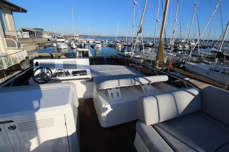  Yacht Photos Pics 2024 Prestige 520 yacht at marina, featuring spacious deck and modern controls.