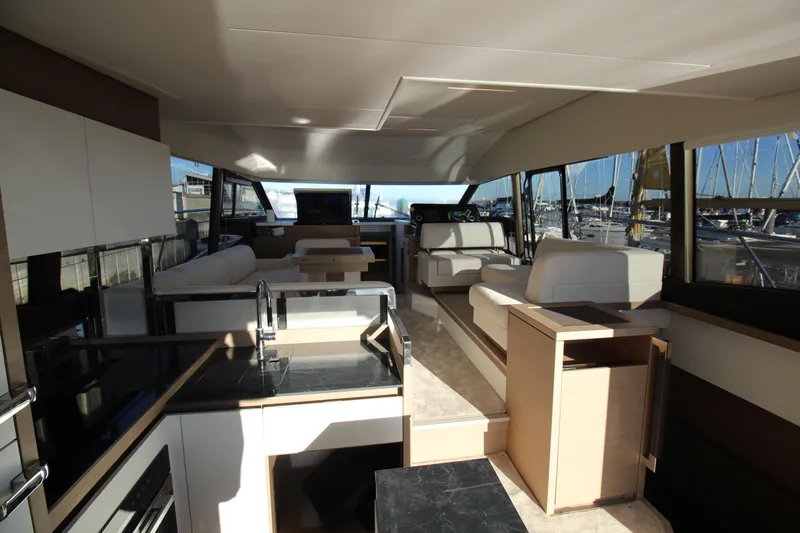  Yacht Photos Pics Luxurious interior of 2024 Prestige 520 yacht with modern furnishings and panoramic windows.