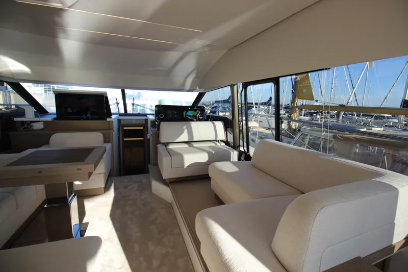  Yacht Photos Pics Luxurious interior of 2024 Prestige 520 yacht with elegant seating and panoramic windows.