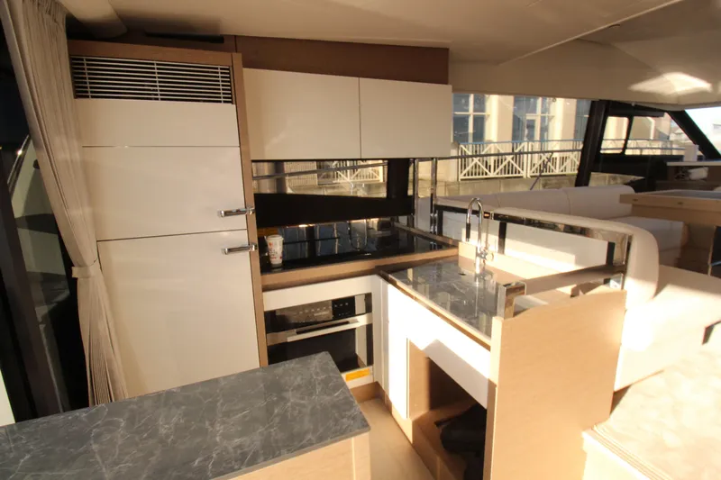  Yacht Photos Pics Modern kitchen interior of 2024 Prestige 520 yacht with sleek design and appliances.