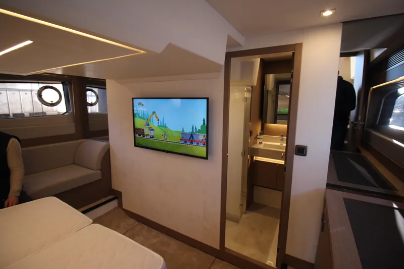  Yacht Photos Pics Luxurious interior of 2024 Prestige 520 yacht with TV and modern bathroom.