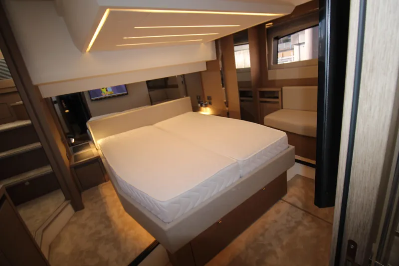  Yacht Photos Pics Luxurious interior of 2024 Prestige 520 yacht with modern bed and ambient lighting.
