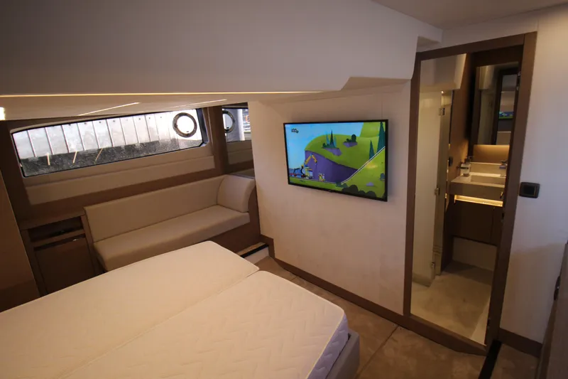 Yacht Photos Pics Luxurious interior of 2024 Prestige 520 yacht with TV and ensuite bathroom.