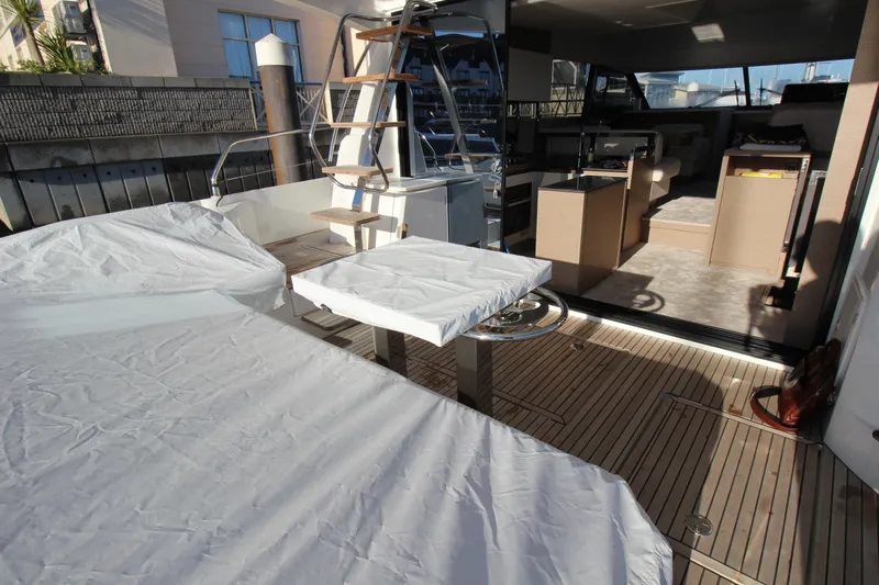  Yacht Photos Pics 2024 Prestige 520 yacht interior with covered seating and modern design.