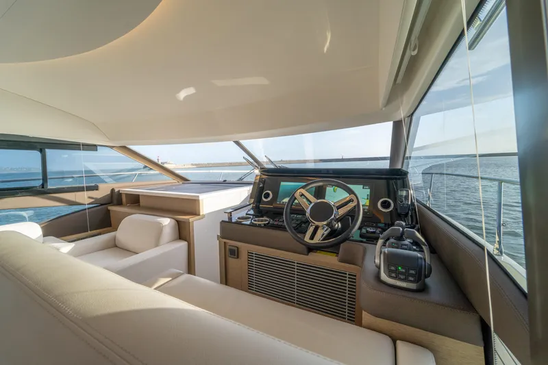  Yacht Photos Pics Interior view of 2024 Prestige 520 yacht cockpit with modern steering and navigation systems.